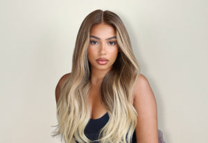 Black woman with long, styled blonde hair wig