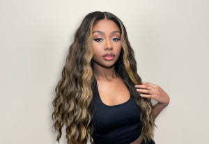 a black woman with long, wavy hair wig