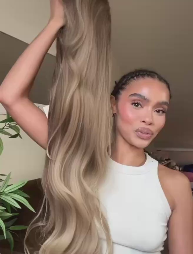 Woman with long hair brown and blonde wig with soft balayage highlights